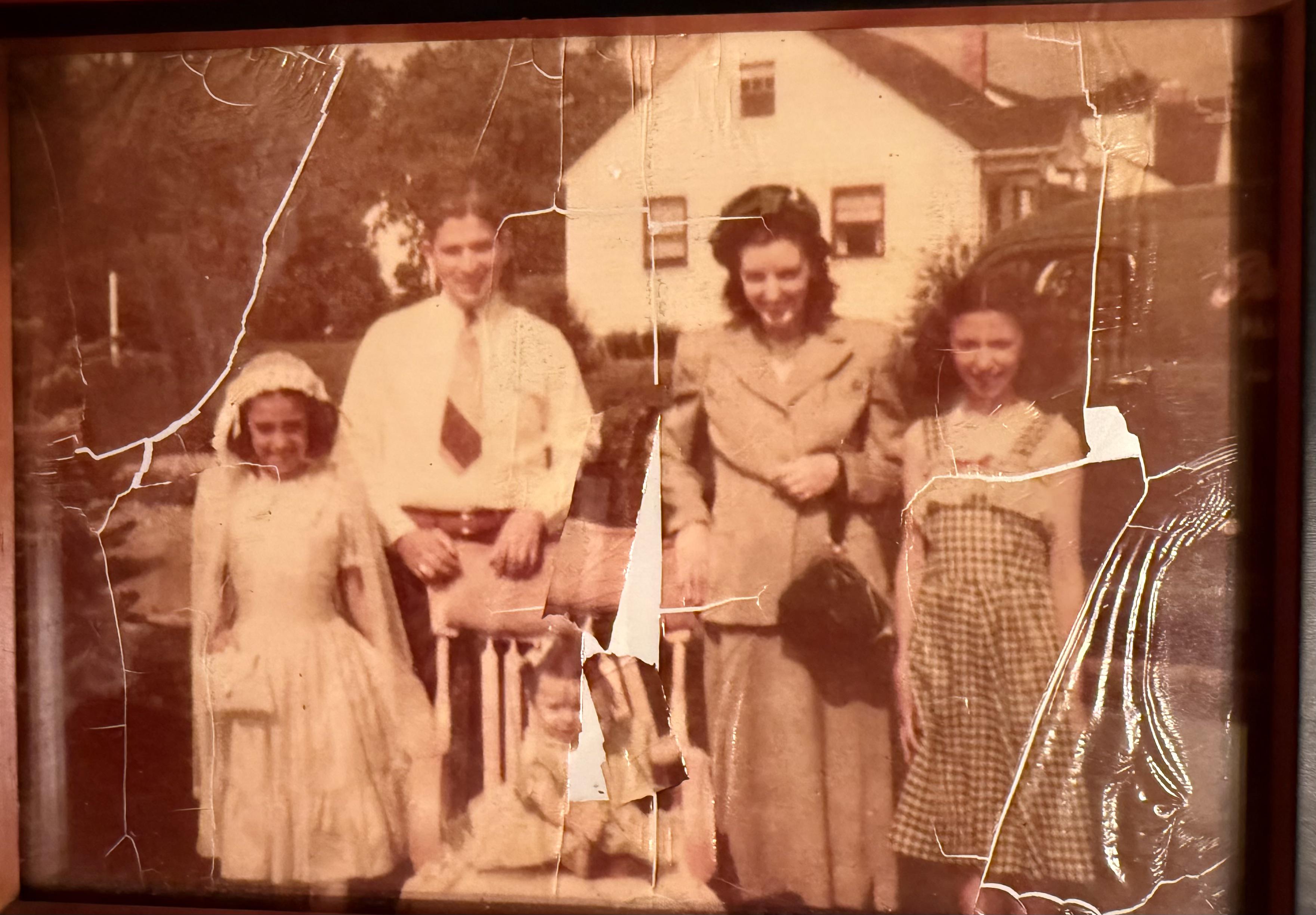 Old photo before restoration, with visible fading and wear.